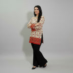 Entici Siara Ruby Swarovski cotton kurti with ethnic print, V-neck, and flared sleeves worn with black trousers.